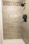 Guest bathroom offers walk in tile shower